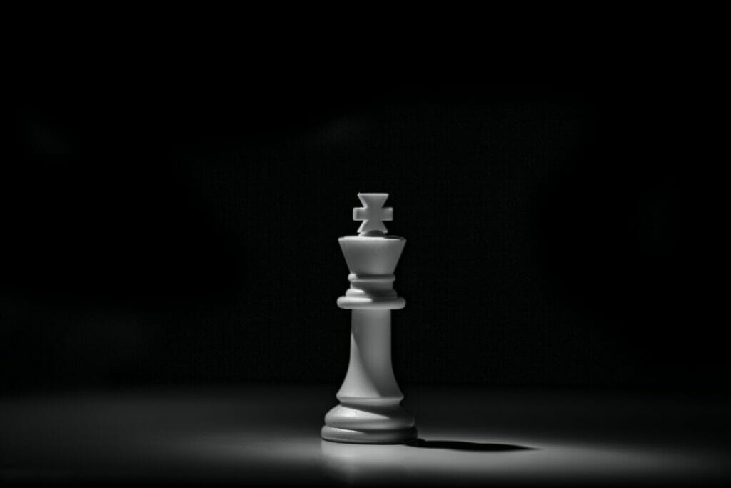 white chess piece on black table